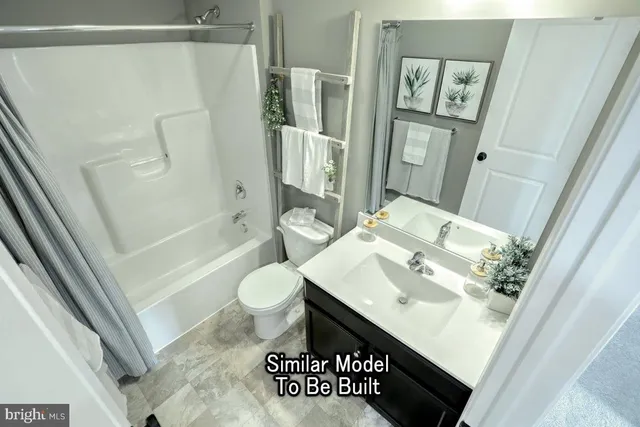 a bathroom with a sink a toilet a mirror and shower