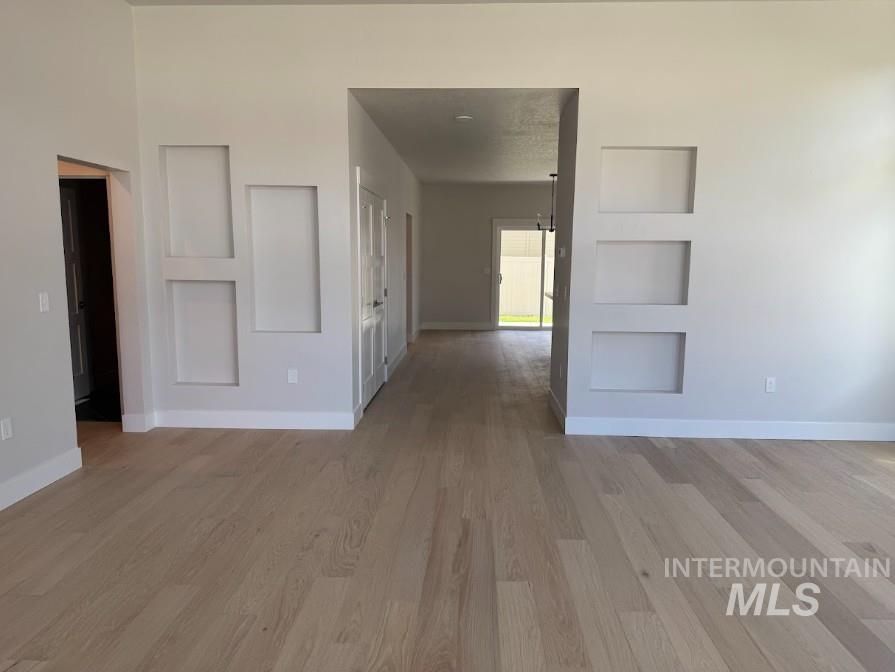 665 West Wrangler Street Meridian, ID 83646 - Photo 6 of 18 Light wood-finish flooring throughout, complemented by white baseboards. Built Ins