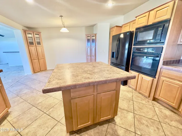a kitchen with a sink a stove and cabinets