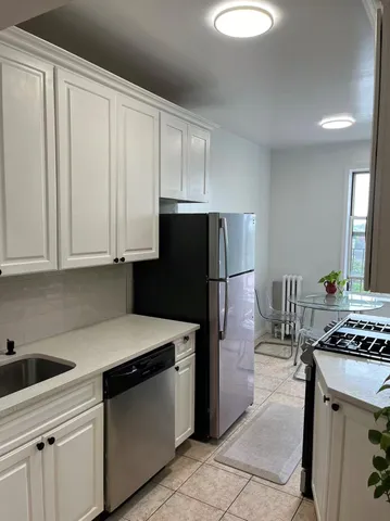 a kitchen with a sink appliances and cabinets