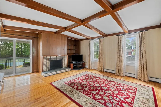 a view of a hallway with wooden floor and furniture