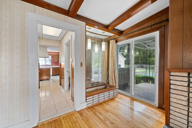 a view of a hallway with wooden floor and glass door