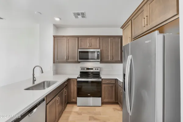 a kitchen with a refrigerator sink and stove