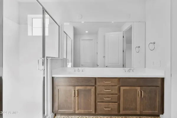a bathroom with a sink double vanity and a mirror