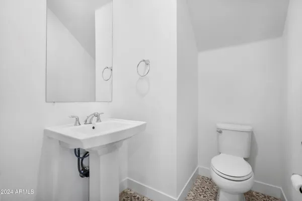 a bathroom with a sink toilet and a mirror