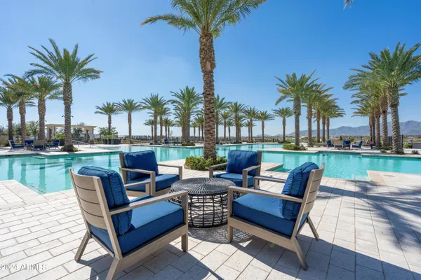 a swimming pool with outdoor seating yard and lake view