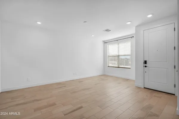 an empty room with windows and closet
