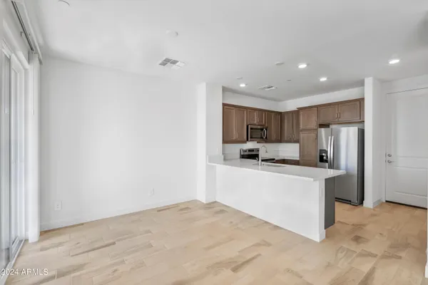 a kitchen with stainless steel appliances a refrigerator and a sink