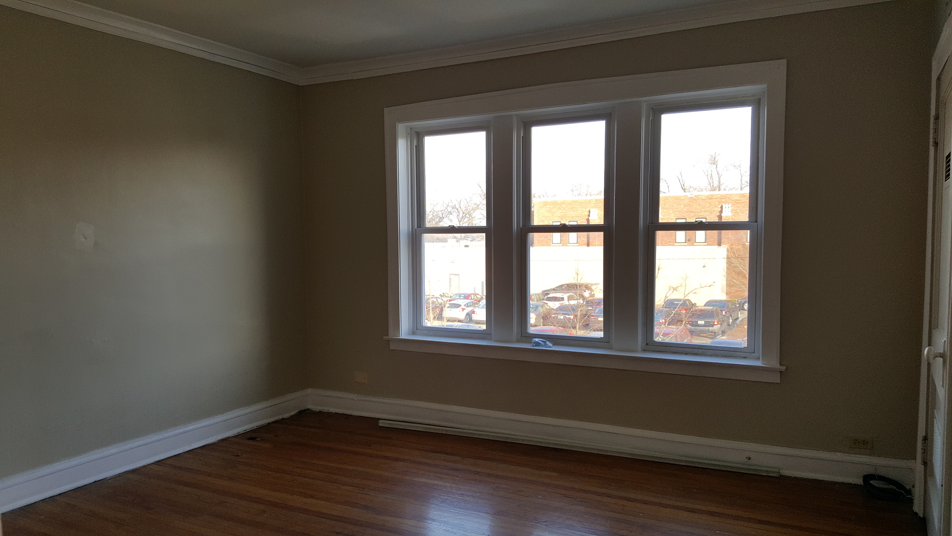 8758 South May Street, Unit 2S Chicago, IL 60620 - Photo 2 of 5 a view of an empty room with wooden floor and a window