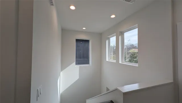 a view of hallway with windows