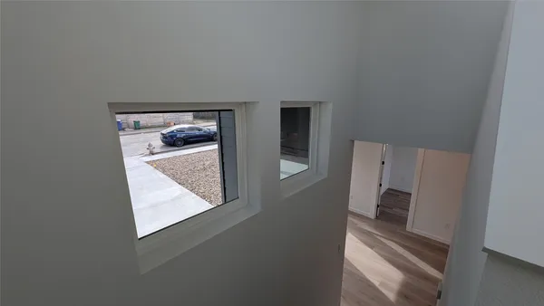 a view of a hallway with windows