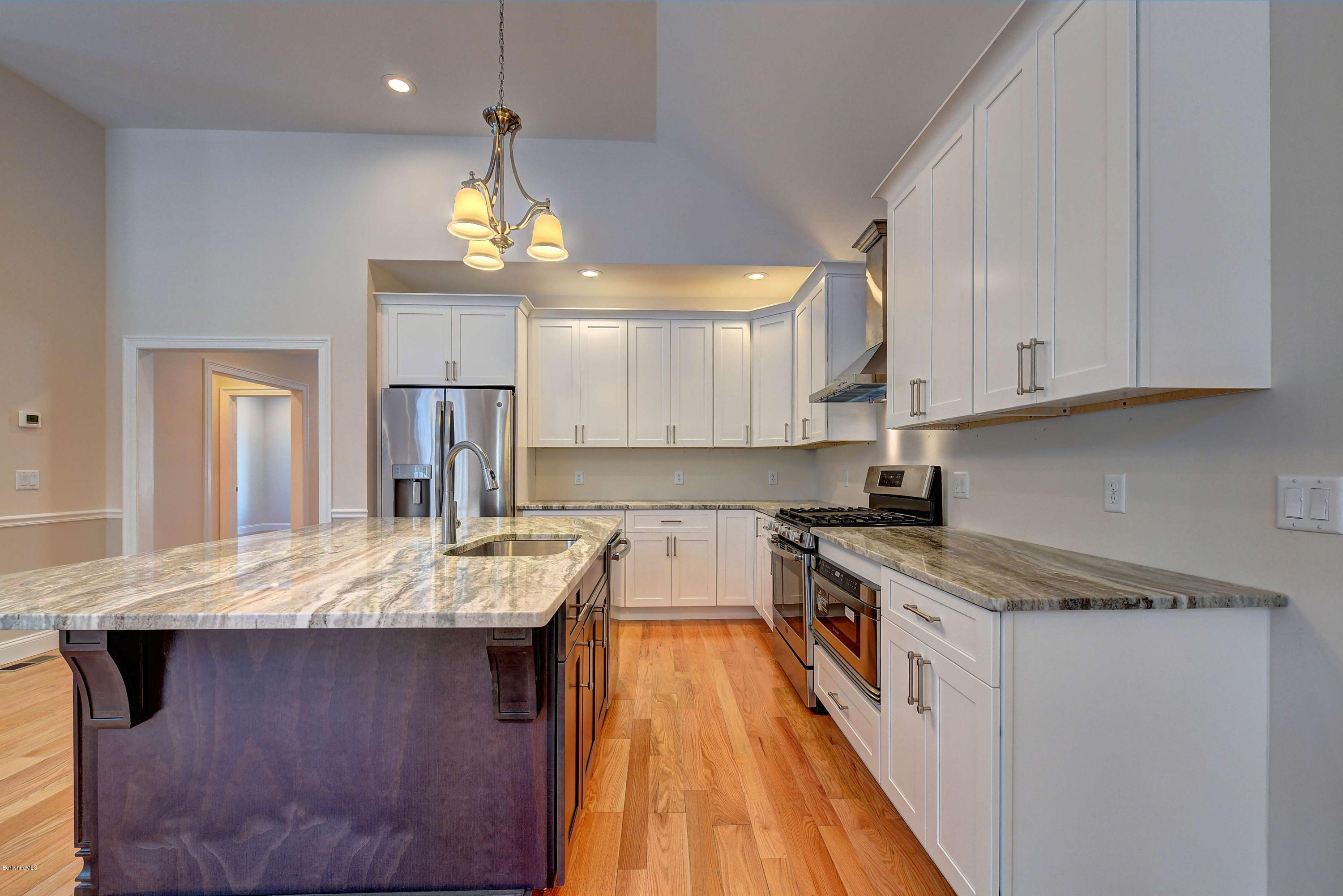 1 B West Dale Road Stockbridge, MA 01262 - Photo 9 of 26 a kitchen with granite countertop cabinets stainless steel appliances and a chandelier