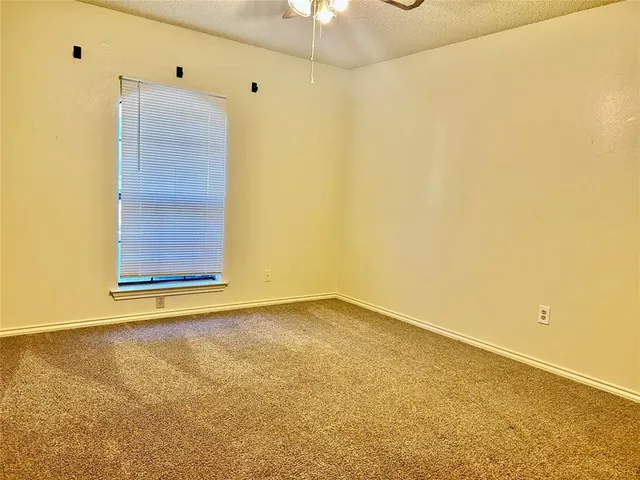 a bathroom with a granite countertop sink a toilet and shower
