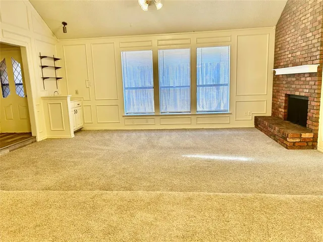 a view of a livingroom with an empty space and a fireplace