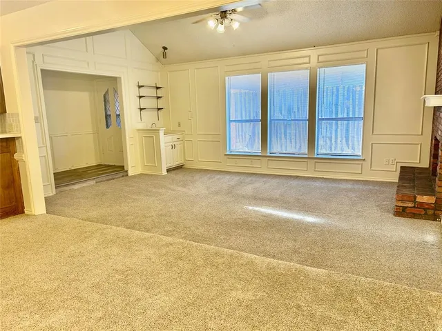 a view of a house with a garage and furniture
