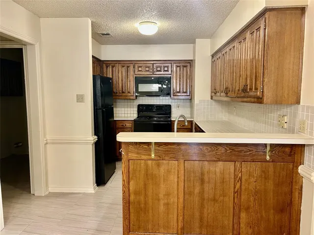 a kitchen with a refrigerator and a sink