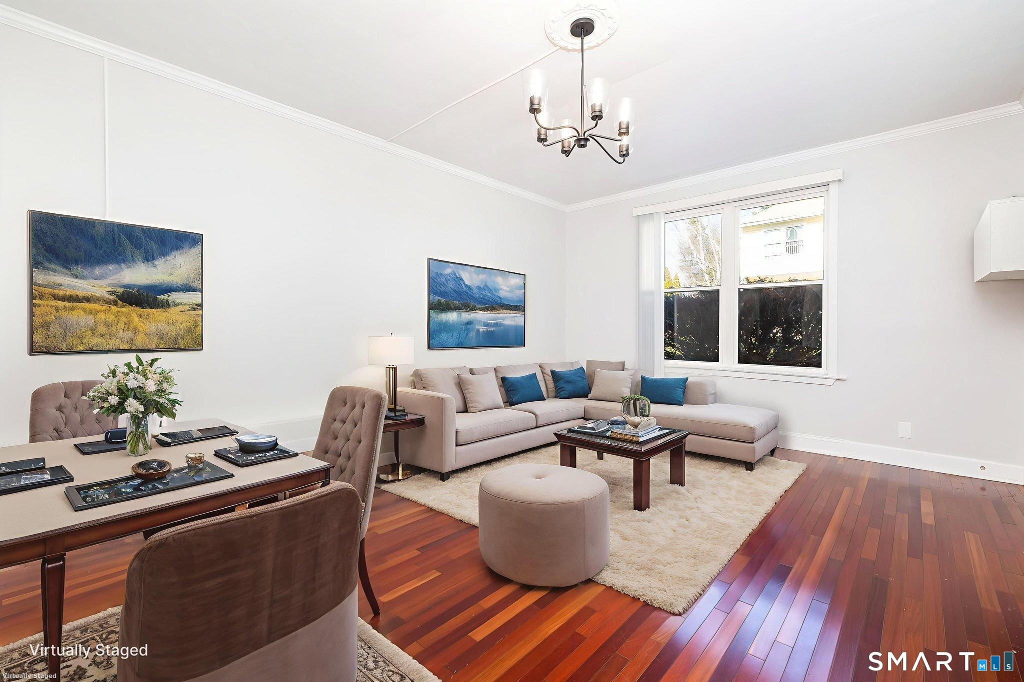 a living room with furniture and a chandelier