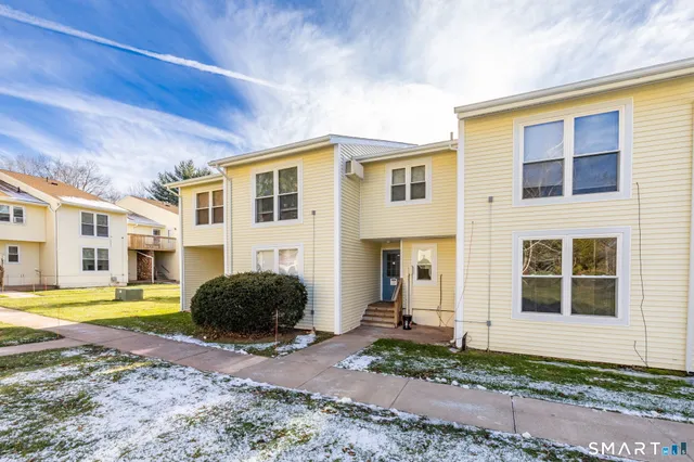 a view of a blue house with a yard