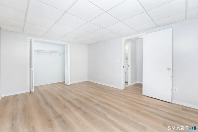 a view of empty room with wooden floor