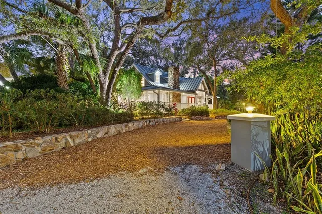 a house outdoor space with lounge chairs and wooden floor