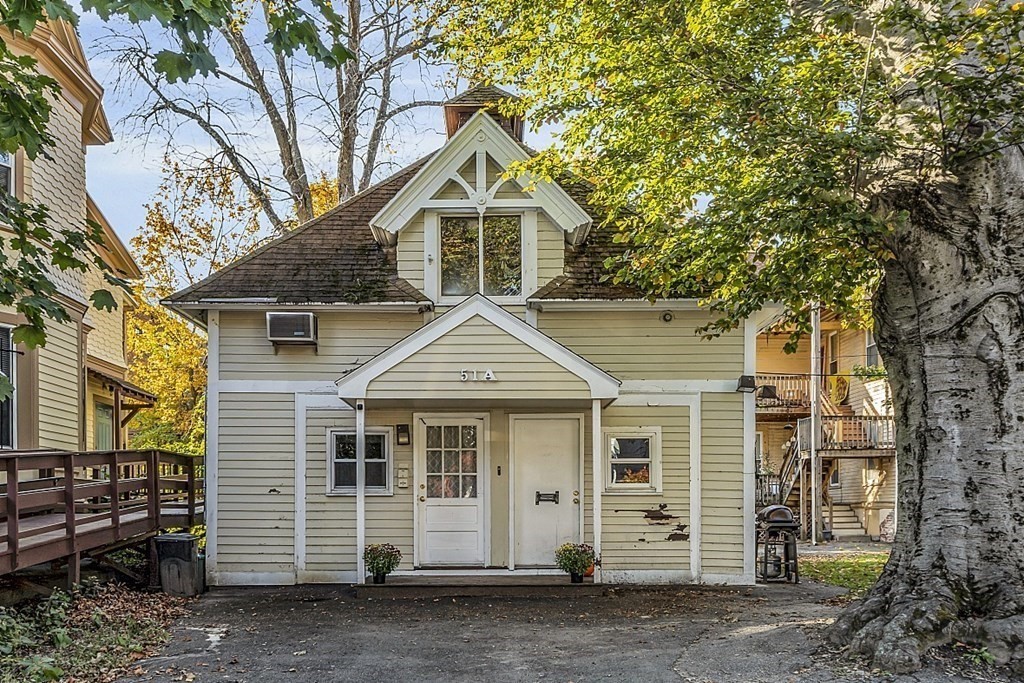 51 A Cedar Street Worcester, MA 01609 - Photo 1 of 27 a front view of a house with a yard