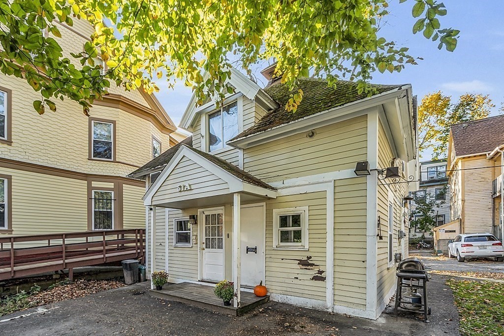 51 A Cedar Street Worcester, MA 01609 - Photo 2 of 27 a front view of a house with a garage