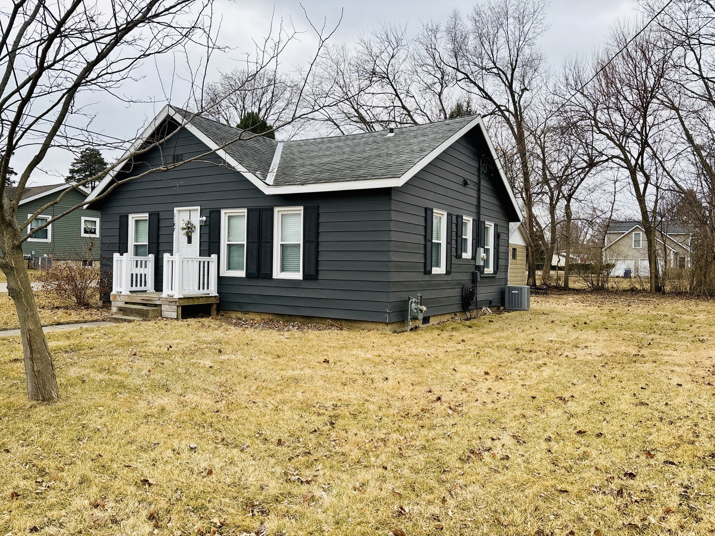 1187 Catherine Street Ottawa, IL 61350 - Photo 2 of 19 a front view of a house with a yard covered in snow