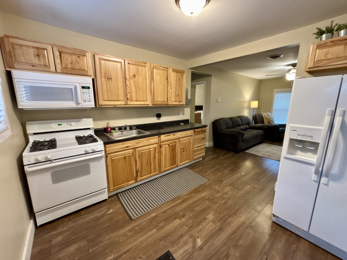 1187 Catherine Street Ottawa, IL 61350 - Photo 7 of 19 a kitchen with a stove a sink and a refrigerator