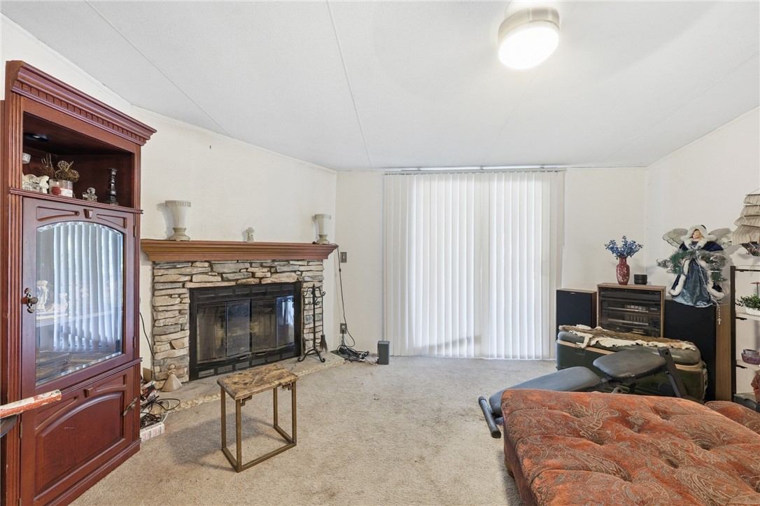 5730 Mockingbird Lane Mathis, TX 78368 - Photo 17 of 40 a bedroom with furniture and a fireplace
