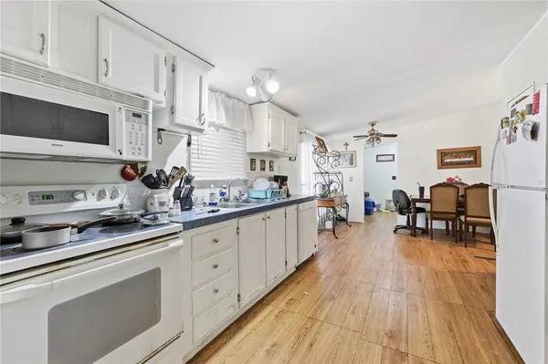 a open kitchen with stainless steel appliances granite countertop a lot of counter space and wooden floors