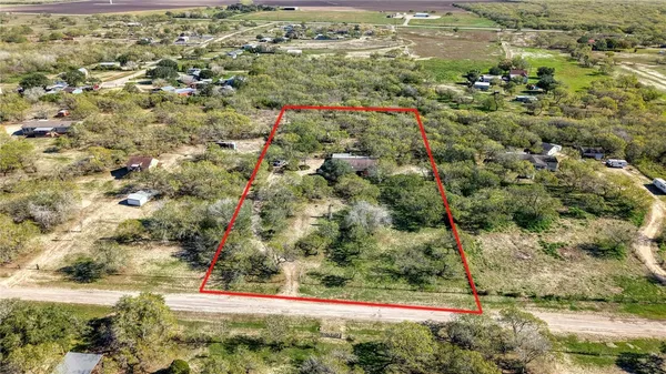 an aerial view of a houses with a yard