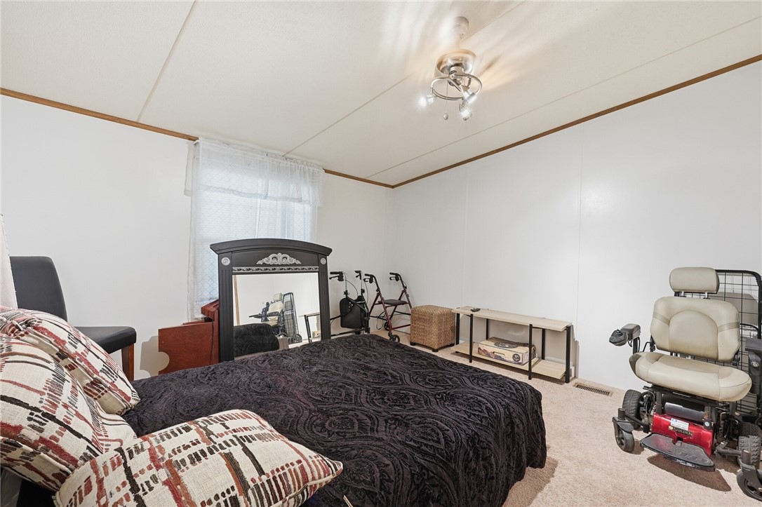 5730 Mockingbird Lane Mathis, TX 78368 - Photo 21 of 40 a bedroom with a bed and a chandelier