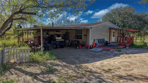 a view of a car park in front of a house