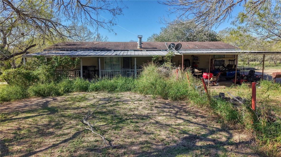 5730 Mockingbird Lane Mathis, TX 78368 - Photo 10 of 40 a view of a patio with table and chairs under an umbrella