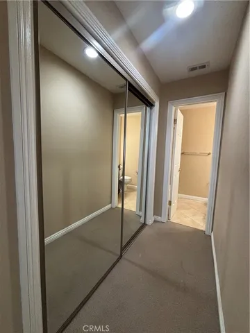 a bathroom with a granite countertop sink toilet and mirror