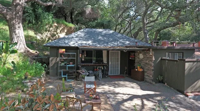 a view of an house with backyard porch and sitting area
