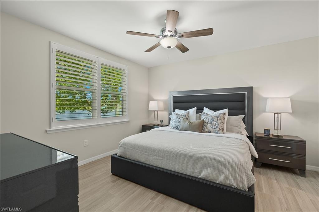 14680 Edgewater Circle Naples, FL 34114 - Photo 12 of 33 a bedroom with a bed and a night stand