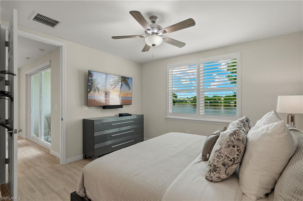 14680 Edgewater Circle Naples, FL 34114 - Photo 13 of 33 a bedroom with a large bed and a window