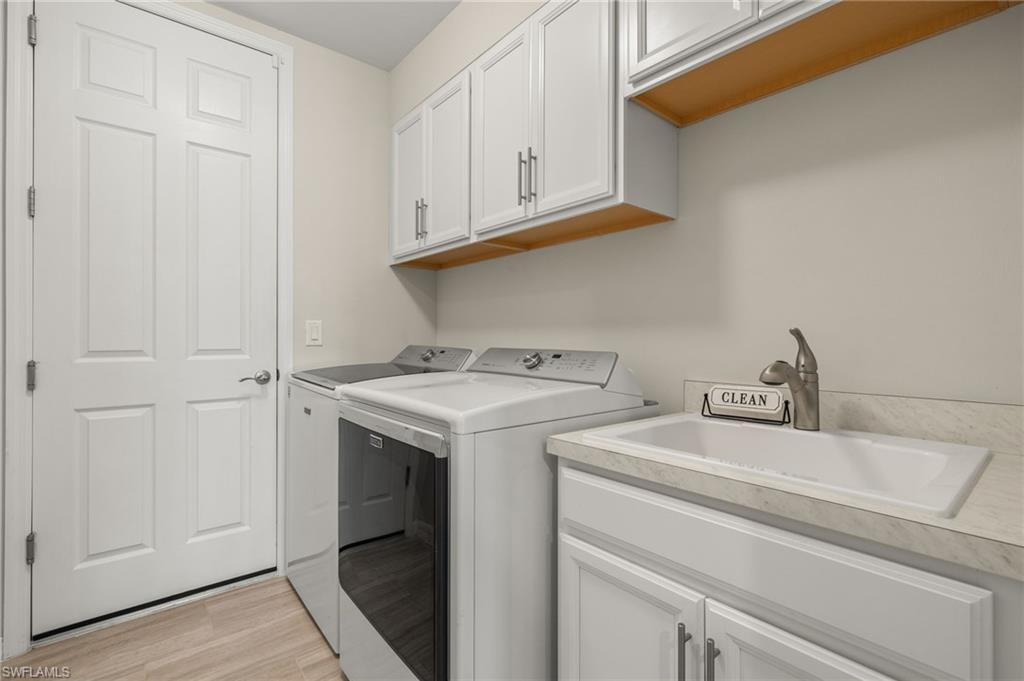 14680 Edgewater Circle Naples, FL 34114 - Photo 19 of 33 a utility room with dryer and washer