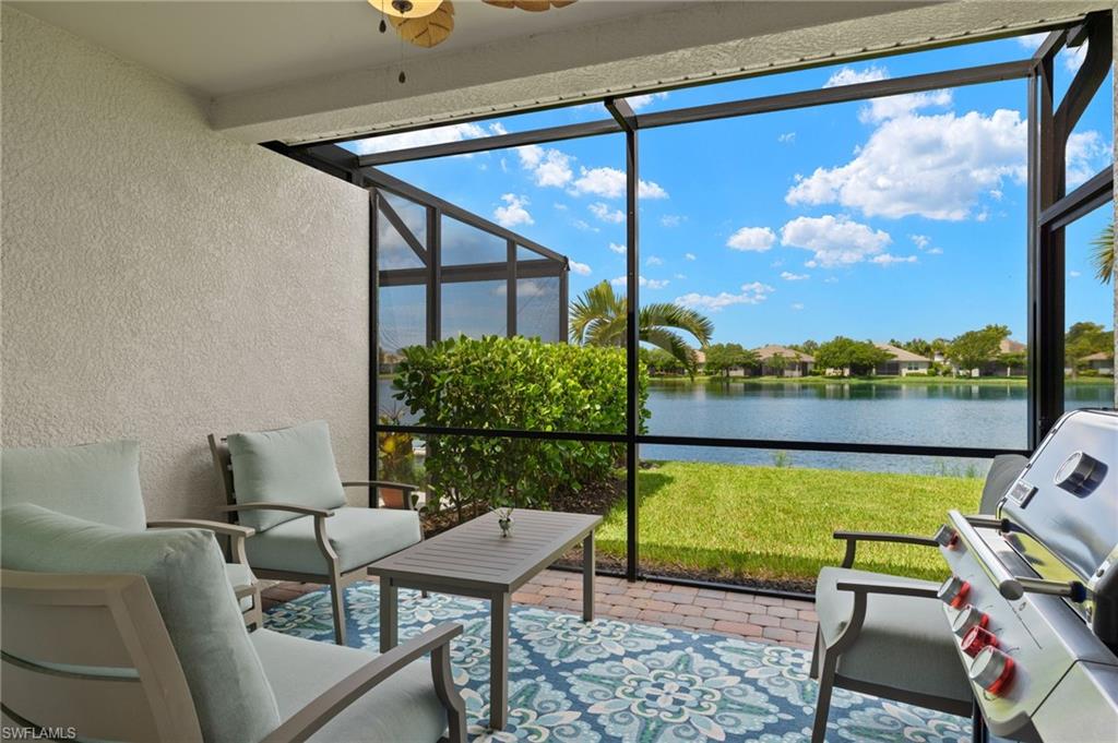 14680 Edgewater Circle Naples, FL 34114 - Photo 20 of 33 a balcony with furniture and a view of lake
