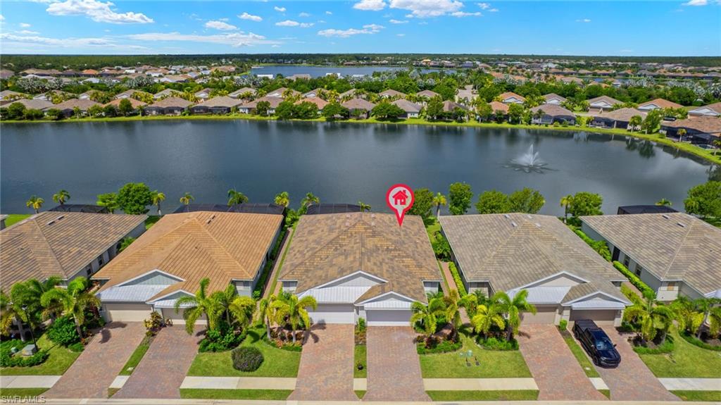 14680 Edgewater Circle Naples, FL 34114 - Photo 22 of 33 an aerial view of a house with a yard and lake view