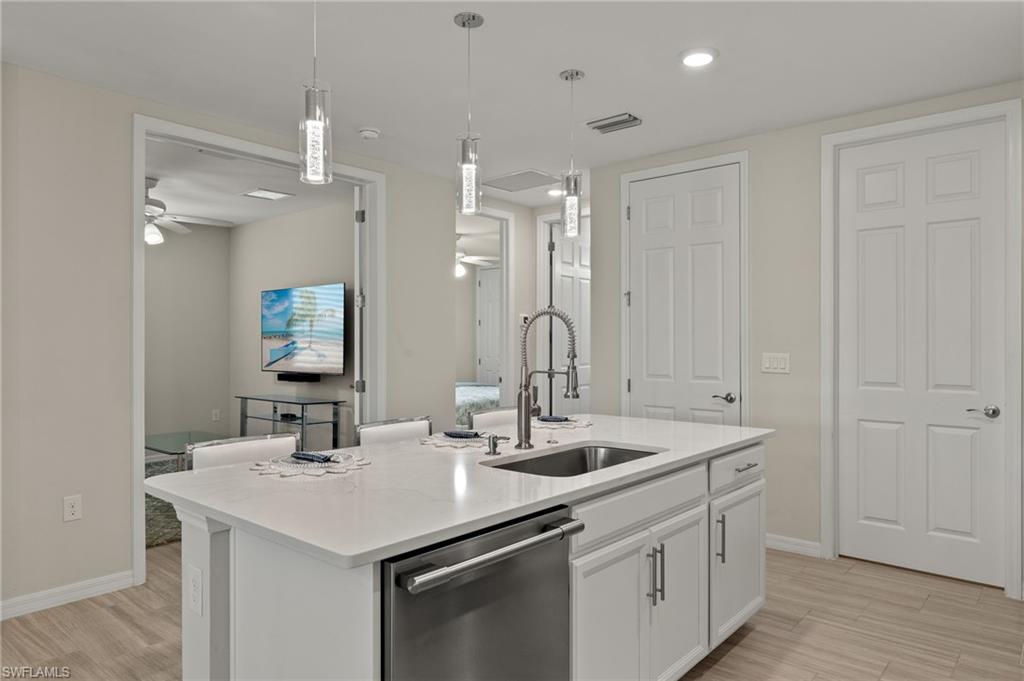 14680 Edgewater Circle Naples, FL 34114 - Photo 6 of 33 a bathroom with a sink double vanity and a mirror