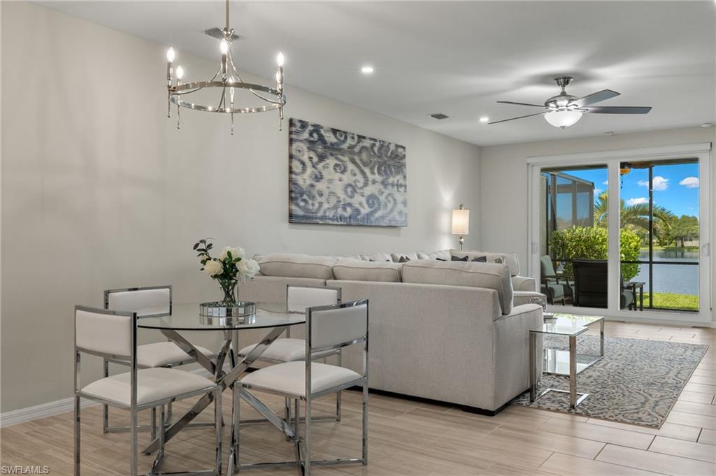 14680 Edgewater Circle Naples, FL 34114 - Photo 8 of 33 a living room with furniture and a chandelier