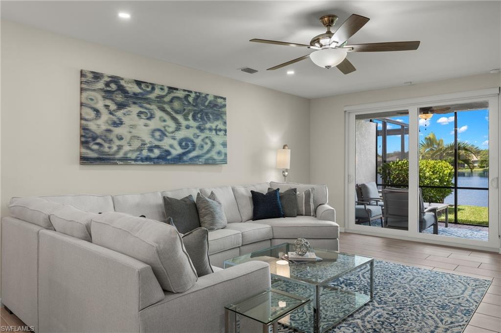 14680 Edgewater Circle Naples, FL 34114 - Photo 10 of 33 a living room with furniture and a chandelier