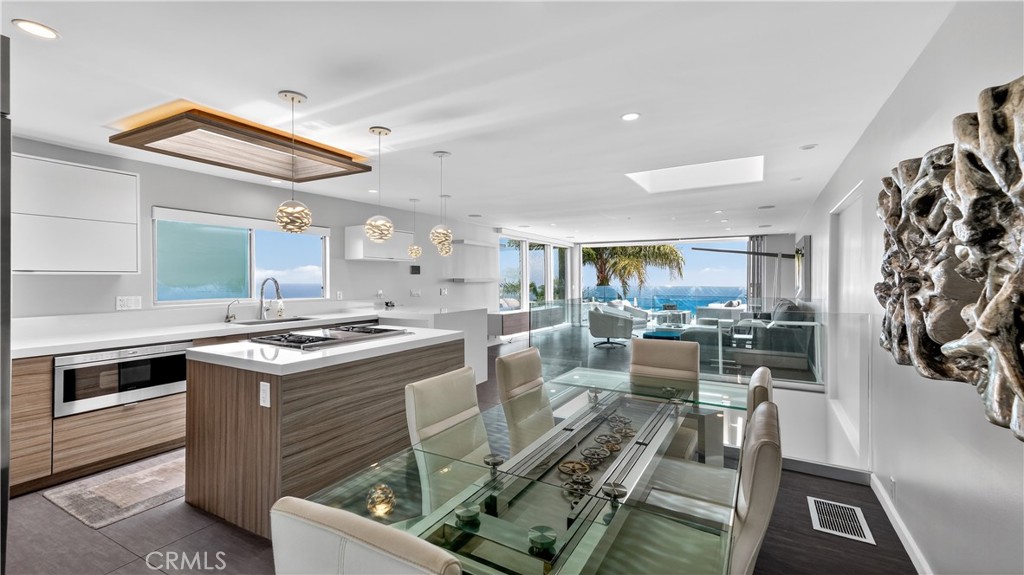 855 Santa Ana Street Laguna Beach, CA 92651 - Photo 11 of 35 a kitchen that has a lot of cabinets a sink and a stove in it