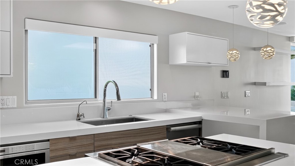 855 Santa Ana Street Laguna Beach, CA 92651 - Photo 13 of 35 a kitchen with a sink and a stove top oven