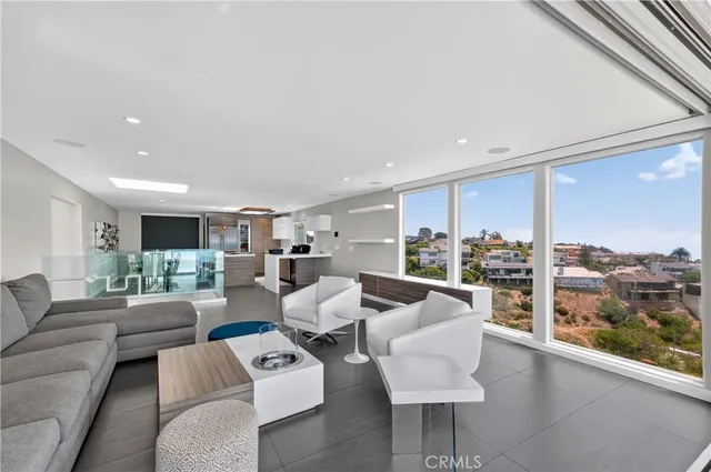 a living room with furniture and a floor to ceiling window
