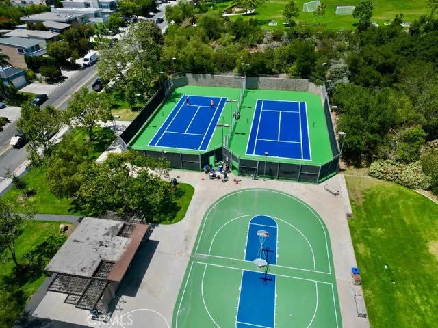 an aerial view of a tennis ground and a yard