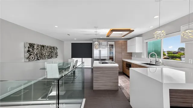 a large white kitchen with a large window