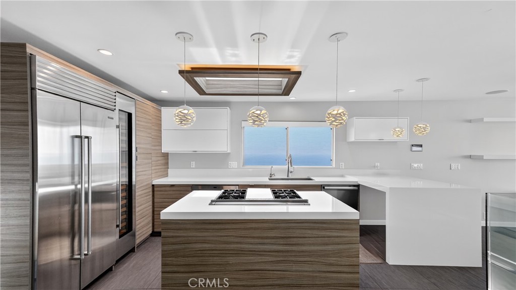 855 Santa Ana Street Laguna Beach, CA 92651 - Photo 9 of 35 a kitchen with stainless steel appliances granite countertop a sink and a refrigerator